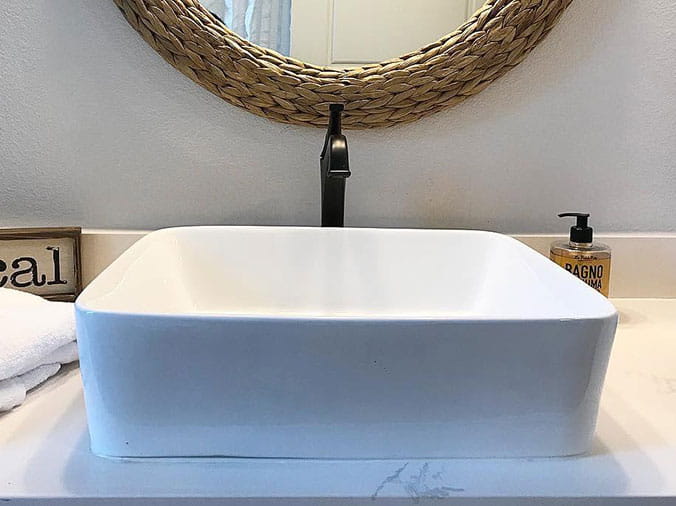 bathroom basin sink with black faucet